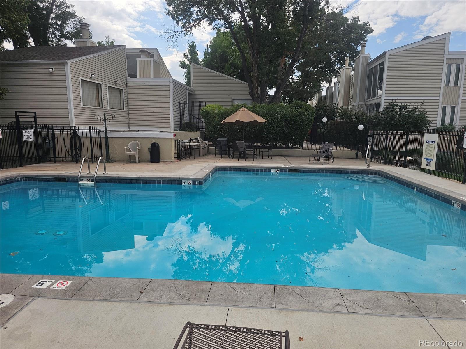 1050 South Monaco Parkway, Unit 93 Denver, CO 80224 - Photo 18 of 20 a view of house with swimming pool outdoor seating