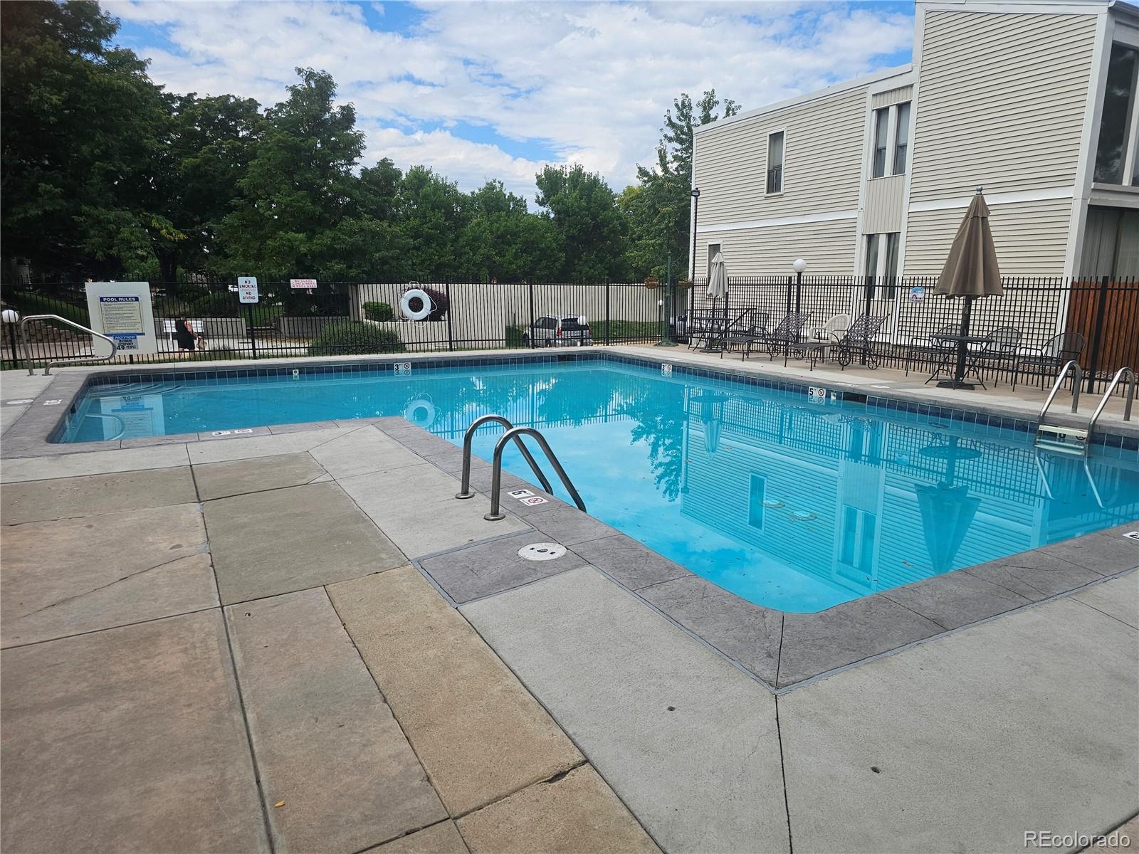 1050 South Monaco Parkway, Unit 93 Denver, CO 80224 - Photo 19 of 20 a view of a swimming pool with a patio