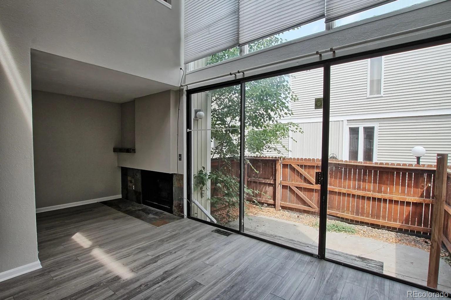 1050 South Monaco Parkway, Unit 93 Denver, CO 80224 - Photo 6 of 20 a view of empty room with wooden floor and fan