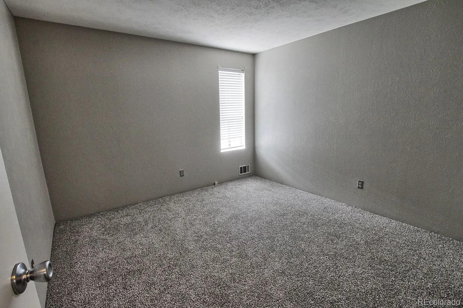 1050 South Monaco Parkway, Unit 93 Denver, CO 80224 - Photo 10 of 20 an empty room with windows