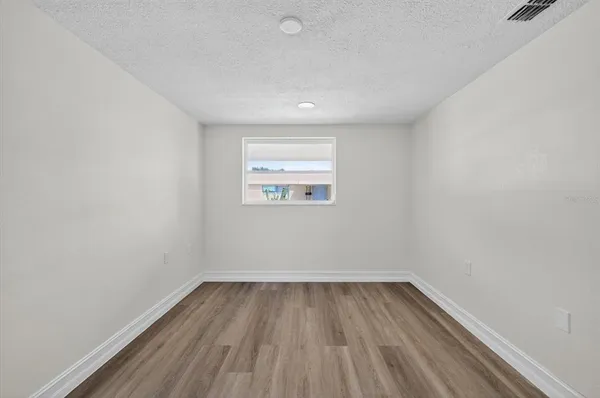 a view of a room with wooden floor and window