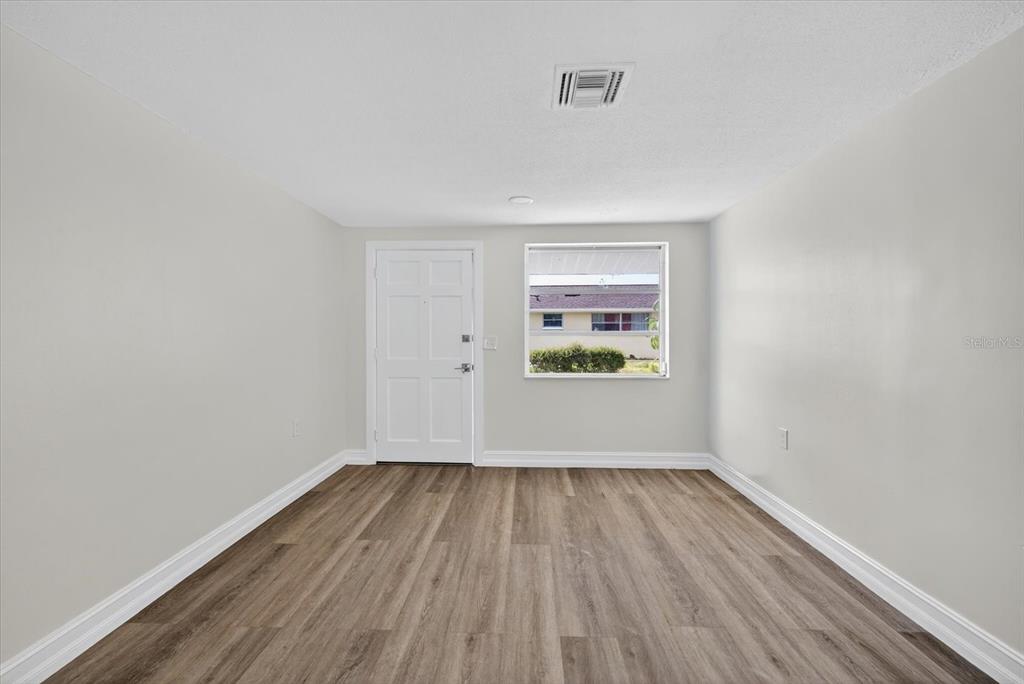 5409 Oceanic Road Holiday, FL 34690 - Photo 18 of 34 a view of room with window and wooden floor