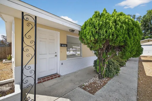 a sign board with potted plants