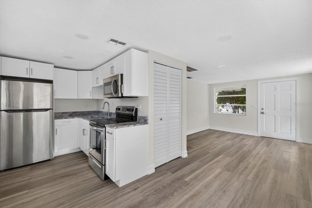 5409 Oceanic Road Holiday, FL 34690 - Photo 22 of 34 a kitchen with wooden floors and refrigerator