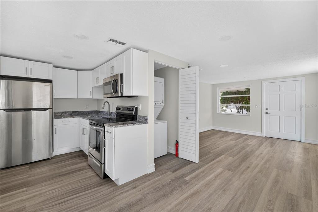 5409 Oceanic Road Holiday, FL 34690 - Photo 25 of 34 a kitchen with a refrigerator and a stove top oven