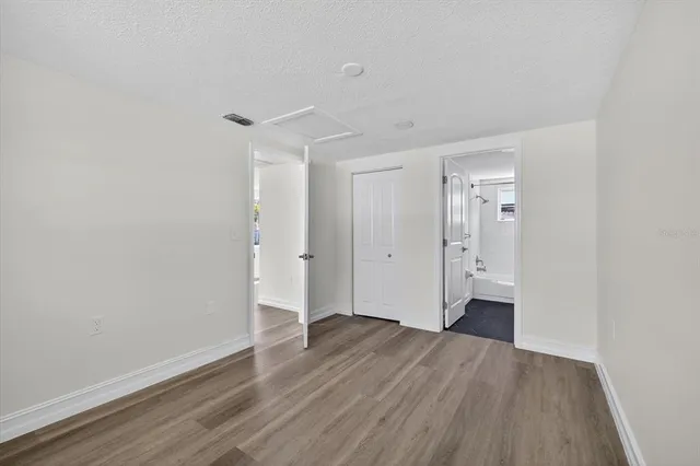 a view of a room with wooden floor and white walls