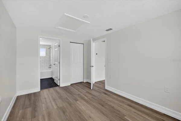 a view of an empty room with wooden floor
