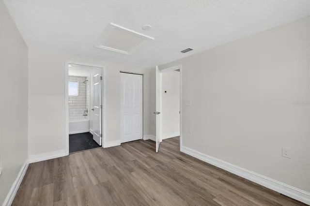 a view of an empty room with wooden floor