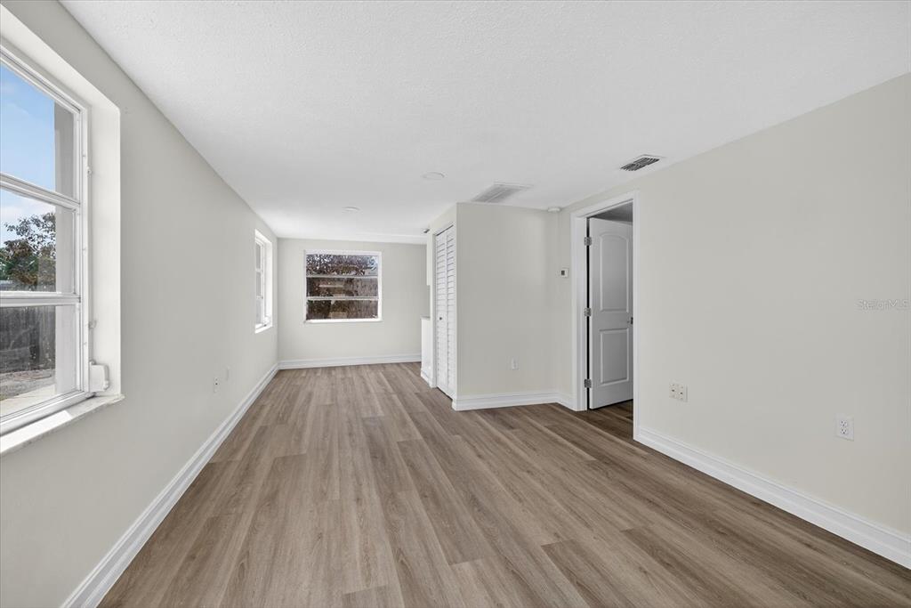 5409 Oceanic Road Holiday, FL 34690 - Photo 4 of 34 a view of an empty room with wooden floor and a window