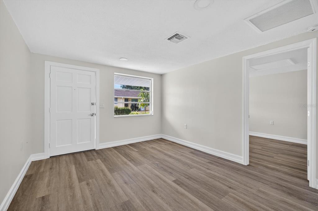 5409 Oceanic Road Holiday, FL 34690 - Photo 5 of 34 a view of an empty room with wooden floor and a window