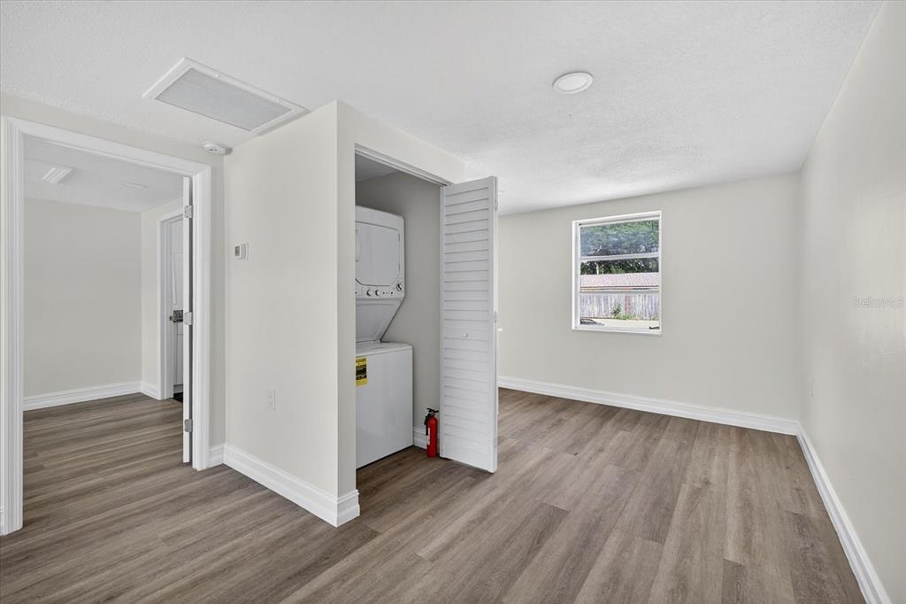 5409 Oceanic Road Holiday, FL 34690 - Photo 9 of 34 a view of a hallway with wooden floor and a bathroom