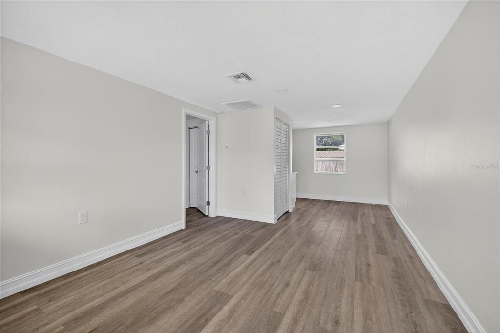 5409 Oceanic Road Holiday, FL 34690 - Photo 10 of 34 an empty room with wooden floor and windows