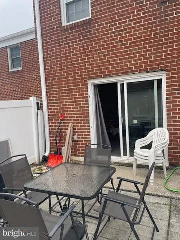a view of a chairs and table in the balcony