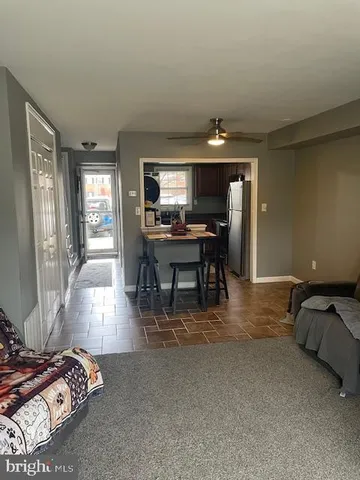 a view of a livingroom with furniture window and wooden floor