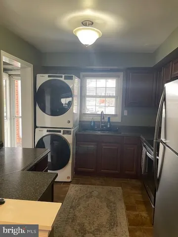 a kitchen with a sink a refrigerator and a stove