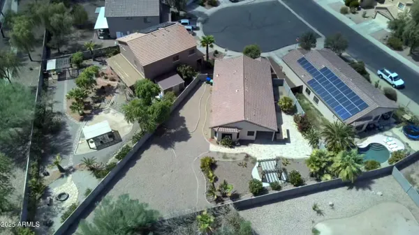 an aerial view of a house with a yard