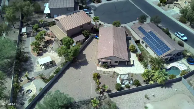 an aerial view of a house with a yard