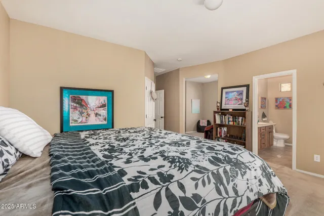 a bedroom with a large bed and a dresser