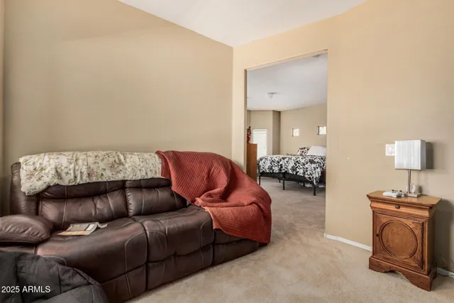 a living room with furniture and a mirror
