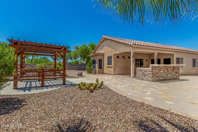a view of a house with backyard and sitting area