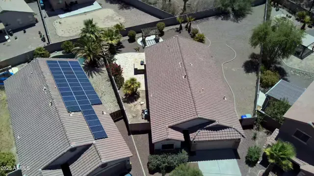 an aerial view of a house with a yard