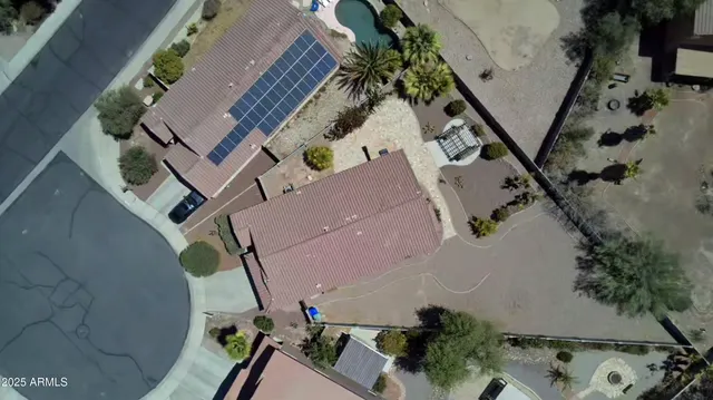 an aerial view of a house with a yard and potted plants
