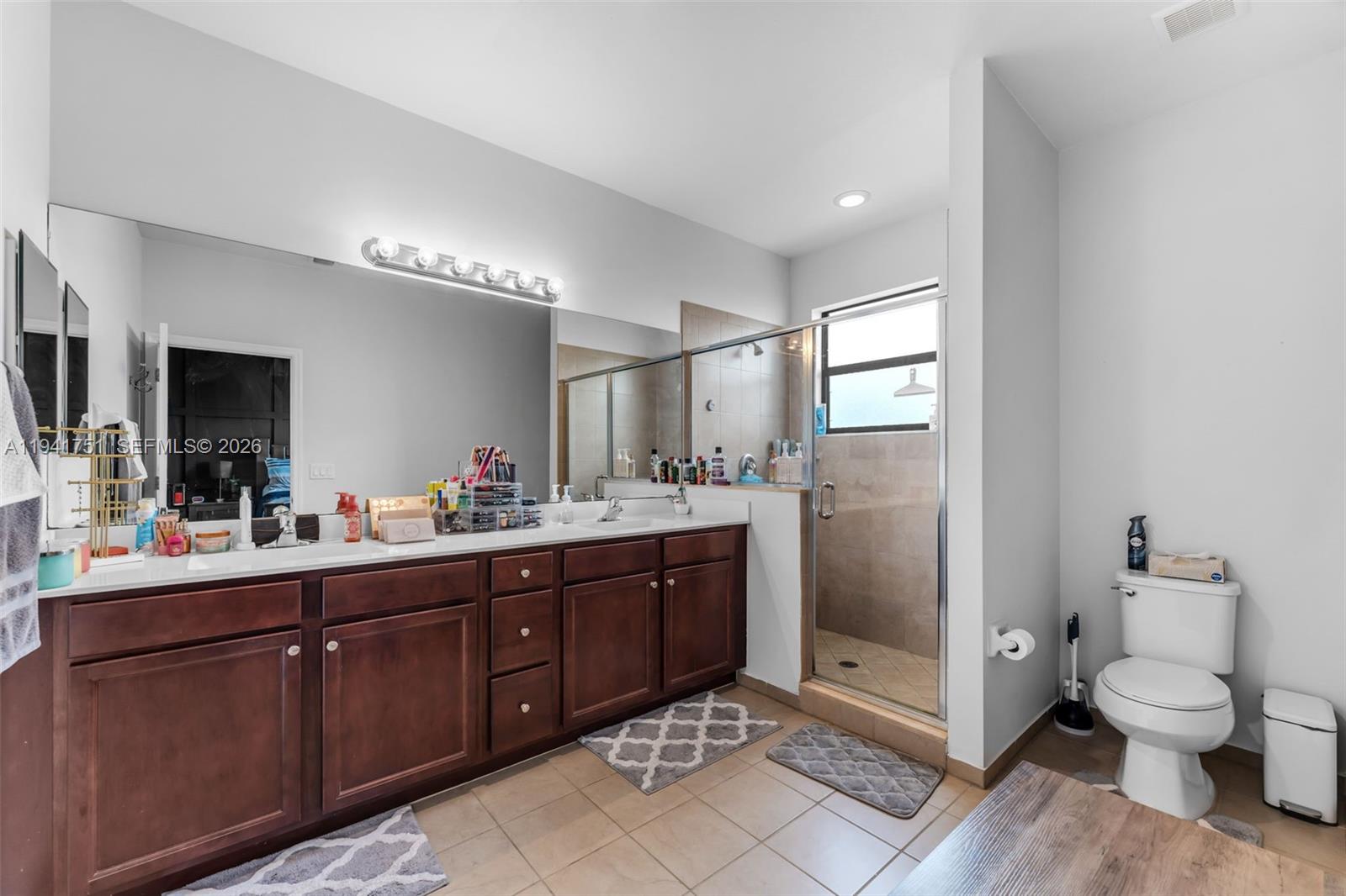 3763 Southeast 2nd Street Homestead, FL 33033 - Photo 15 of 48 a bathroom with a double vanity sink toilet and shower