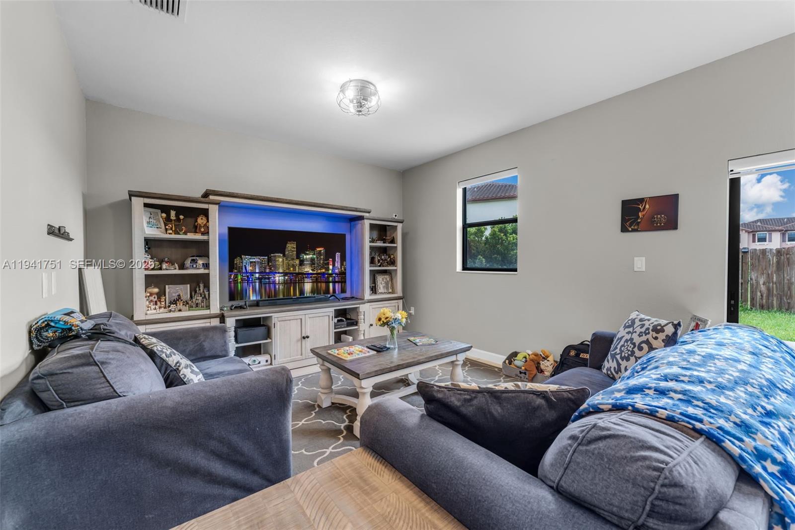 3763 Southeast 2nd Street Homestead, FL 33033 - Photo 6 of 48 a living room with furniture and a flat screen tv