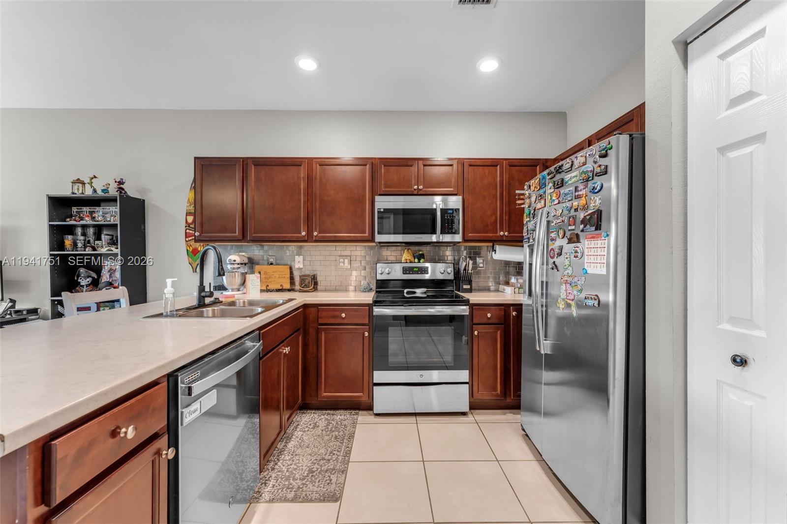 3763 Southeast 2nd Street Homestead, FL 33033 - Photo 8 of 48 a kitchen with stainless steel appliances granite countertop a refrigerator and a sink