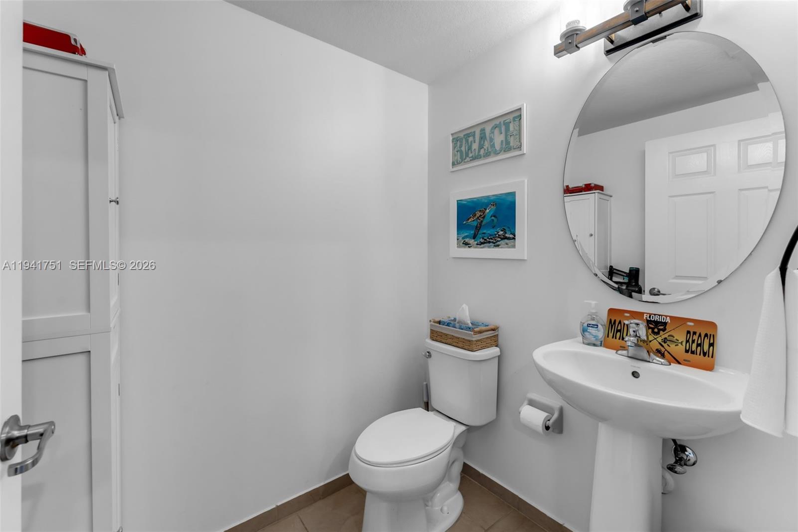 3763 Southeast 2nd Street Homestead, FL 33033 - Photo 10 of 48 a white toilet sitting next to a bathroom sink