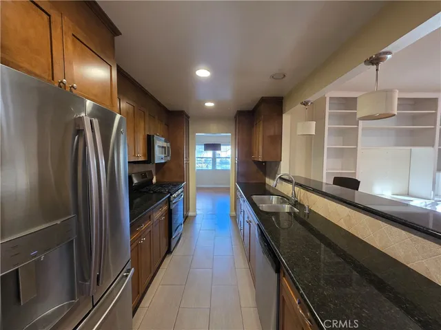 a kitchen with a refrigerator and a sink