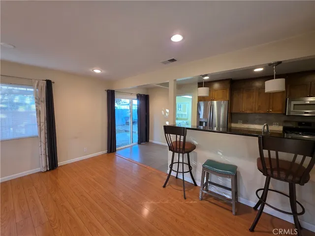 a view of a livingroom with furniture a table and chairs
