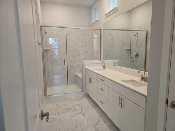 a bathroom with a shower sink and mirror