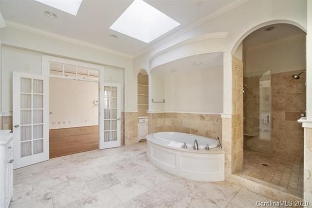 8355 Providence Road Charlotte, NC 28270 - Photo 14 of 36 a bathroom with a tub shower and mirror