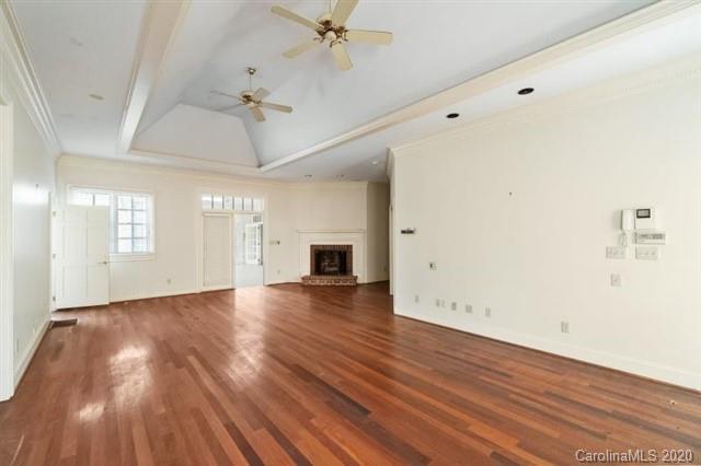 8355 Providence Road Charlotte, NC 28270 - Photo 16 of 36 an empty room with wooden floor chandelier and windows
