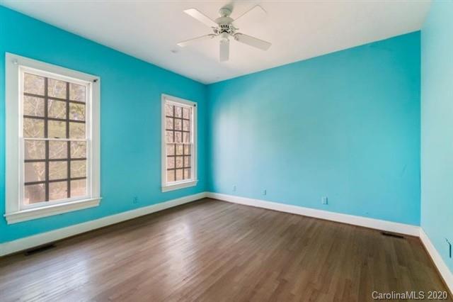 8355 Providence Road Charlotte, NC 28270 - Photo 20 of 36 an empty room with wooden floor chandelier and windows