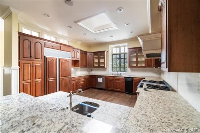 8355 Providence Road Charlotte, NC 28270 - Photo 23 of 36 a kitchen with stainless steel appliances kitchen island granite countertop a refrigerator and stove