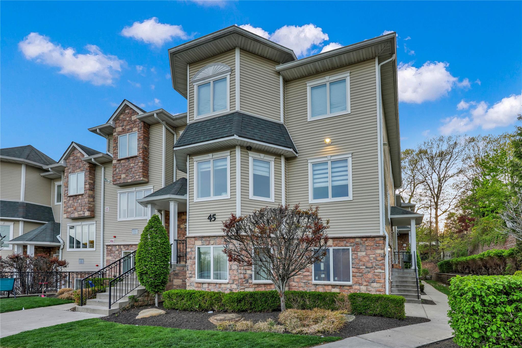 45 Bluefield Drive Spring Valley, NY 10977 - Photo 1 of 1 Townhome / multi-family property featuring roof with shingles and stone siding