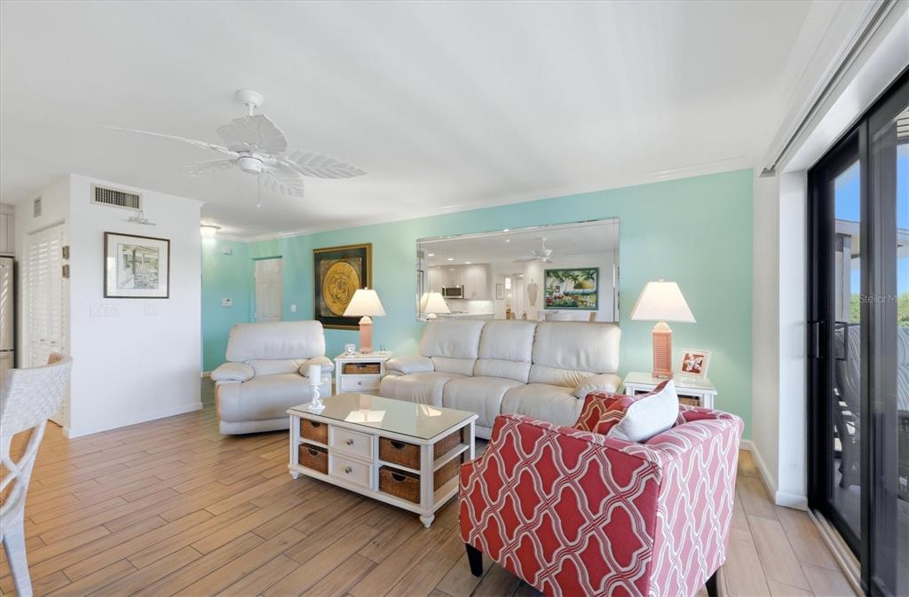 2729 North Beach Road, Unit 211 Englewood, FL 34223 - Photo 27 of 51 a living room with furniture and wooden floor