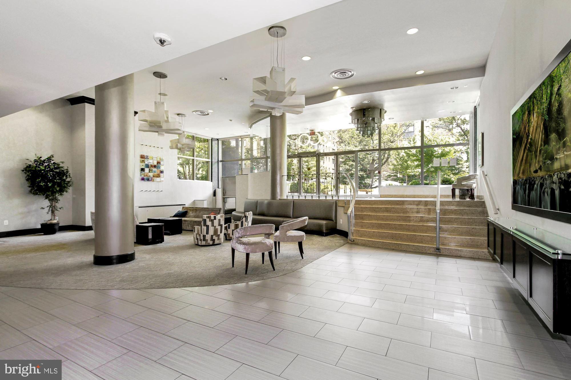 a lobby with furniture and large windows