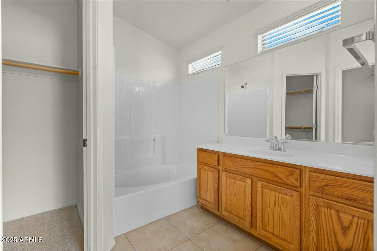 2150 East Bell Road, Unit 1134 Phoenix, AZ 85022 - Photo 22 of 37 a bathroom with a tub shower and sink