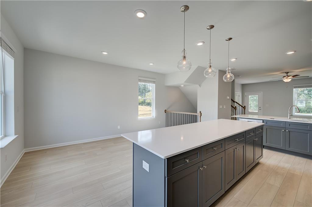 313 Daybreak Lane Newnan, GA 30265 - Photo 13 of 26 a kitchen with a sink a counter top space and living room area