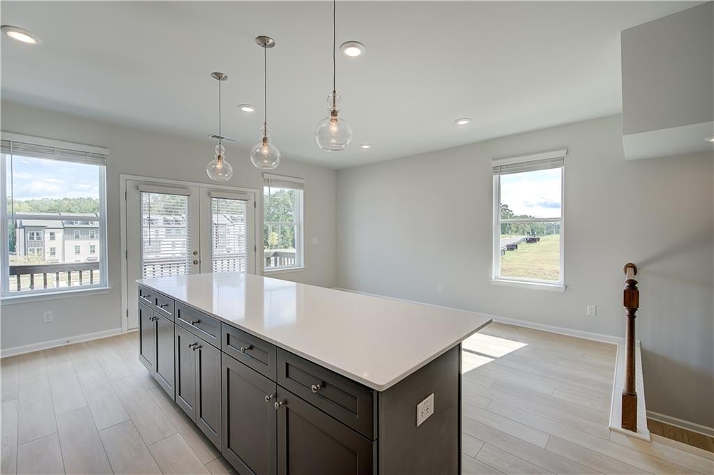 313 Daybreak Lane Newnan, GA 30265 - Photo 15 of 26 a large kitchen with kitchen island a large island in it