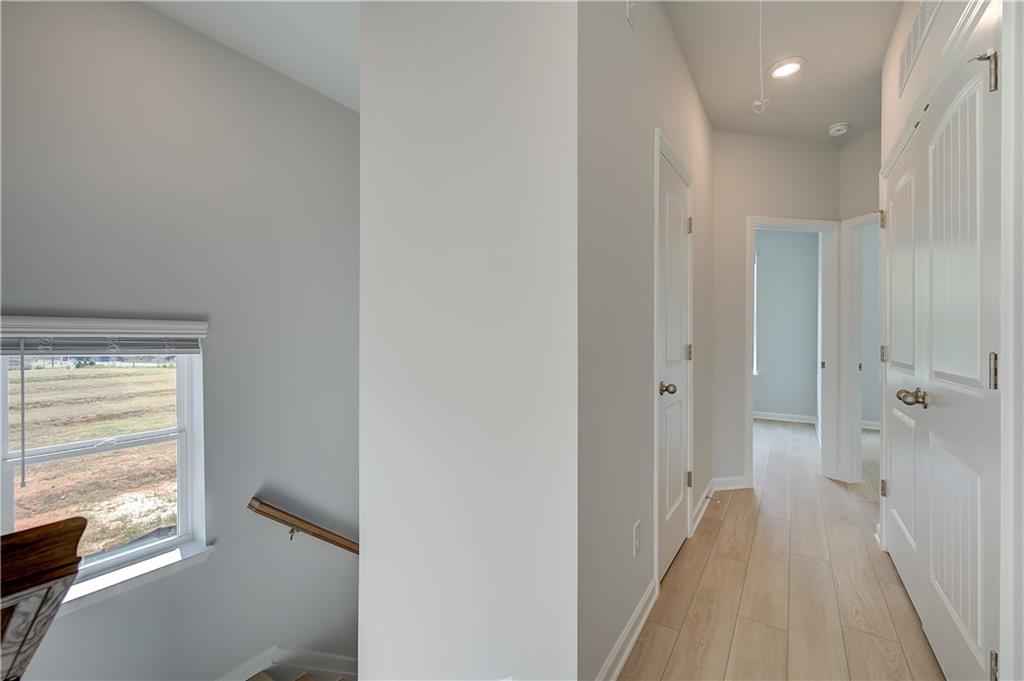 313 Daybreak Lane Newnan, GA 30265 - Photo 18 of 26 a view of a hallway with wooden floor and a bathroom