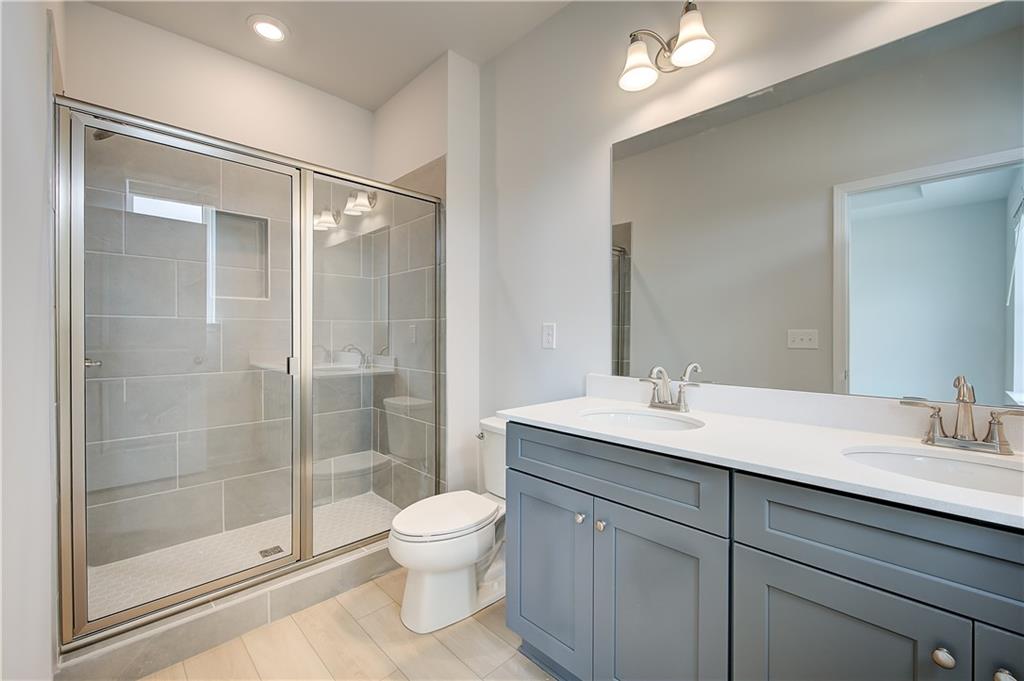 313 Daybreak Lane Newnan, GA 30265 - Photo 24 of 26 a bathroom with a sink a toilet and shower