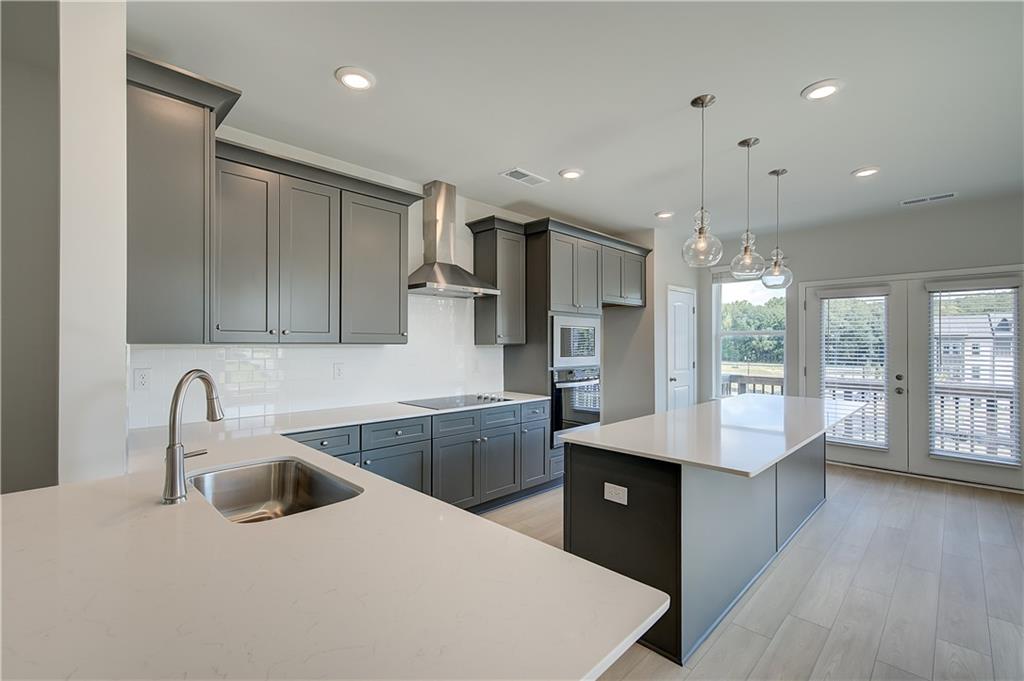 313 Daybreak Lane Newnan, GA 30265 - Photo 10 of 26 a kitchen with stainless steel appliances a sink stove and refrigerator
