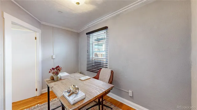 a view of a workspace with furniture and wooden floor