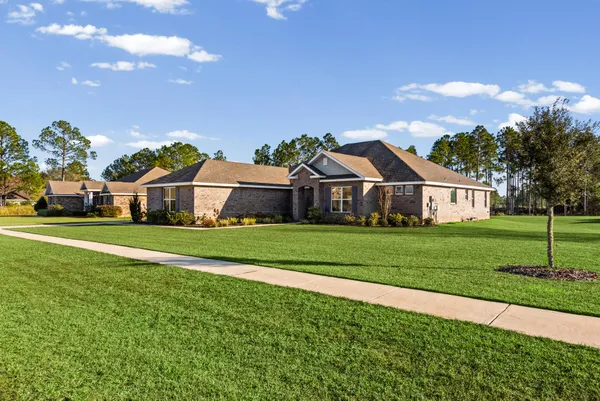 a front view of house with yard and green space