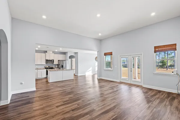 a view of kitchen and hall with wooden floor