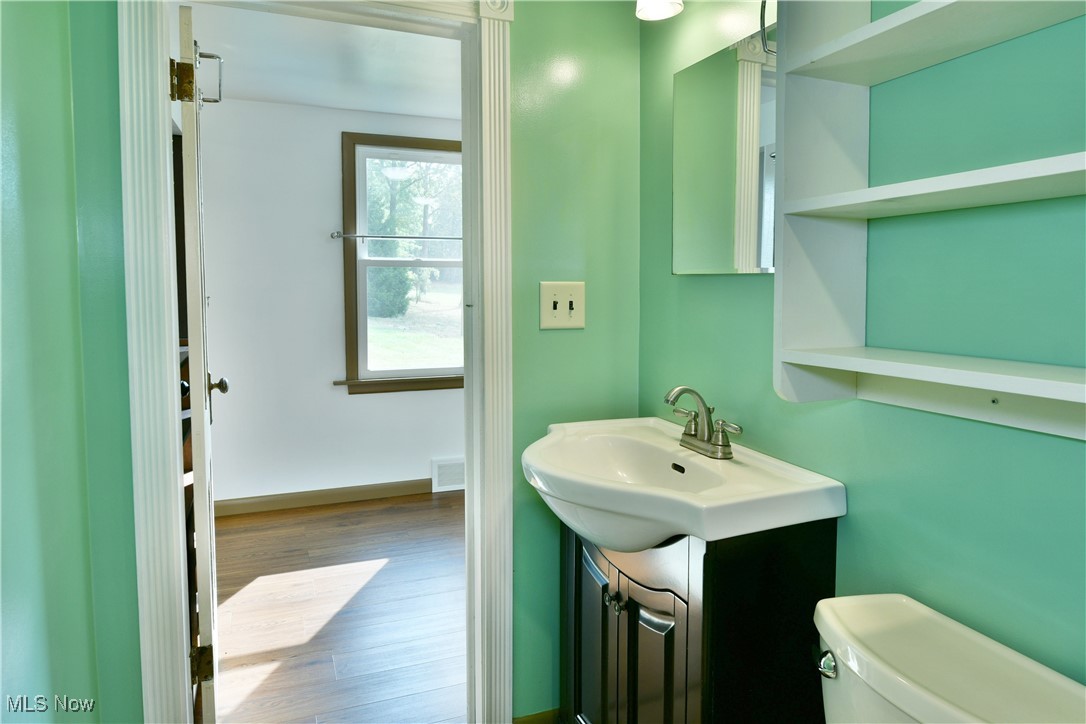 5150 Phillips Rice Road Cortland, OH 44410 - Photo 38 of 50 Half bath featuring vanity and wood finished floors